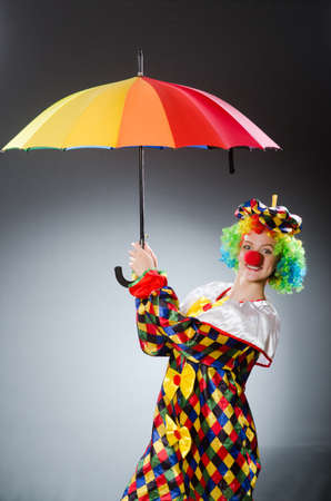 Clown with umbrella in funny conceptの写真素材