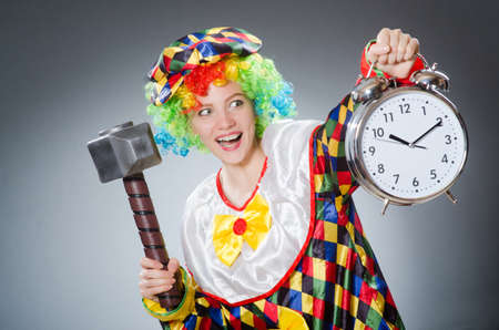 Clown with hammer and clockの写真素材