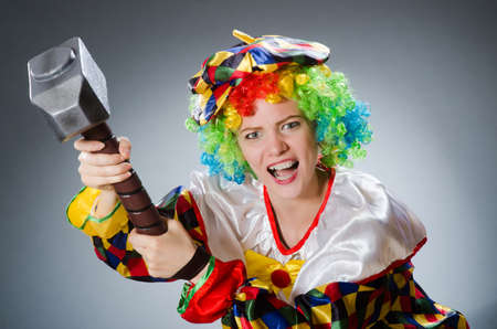Clown with hammer in funny conceptの写真素材