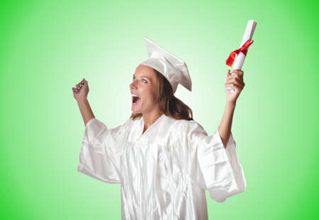 Young student with diploma on whiteの写真素材