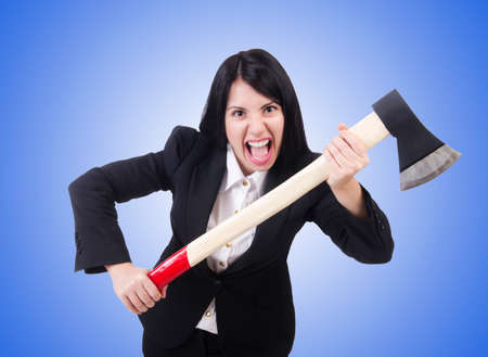 Angry businesswoman with axe on whiteの写真素材
