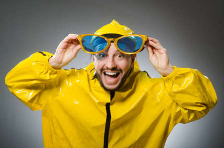 Man wearing yellow suit in funny conceptの写真素材