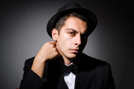 Young businessman in dark studioの写真素材