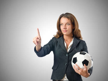 Businesswoman with football on whiteの写真素材
