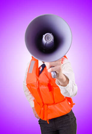Young woman with vest and loudspeaker on whiteの写真素材