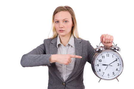 Businesswoman in gray suit holding alarm clock isolated on whiteの写真素材