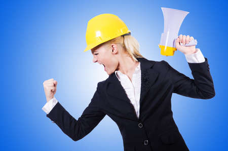 Female construction worker with loudspeakerの写真素材