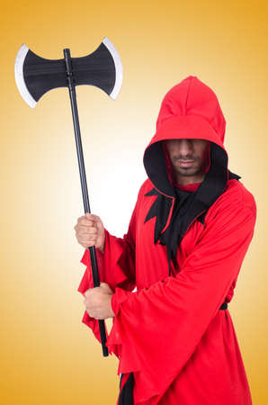 Executioner in red costume with axe on whiteの写真素材