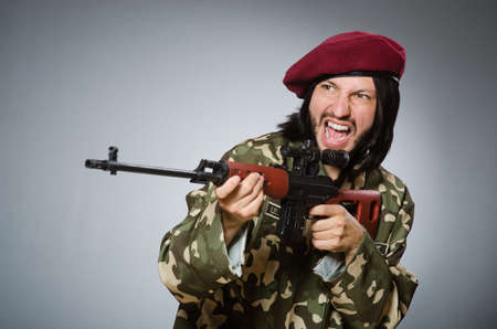 Soldier with handgun against grayの写真素材