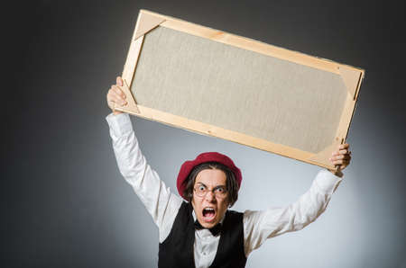 Funny artist in dark studioの写真素材