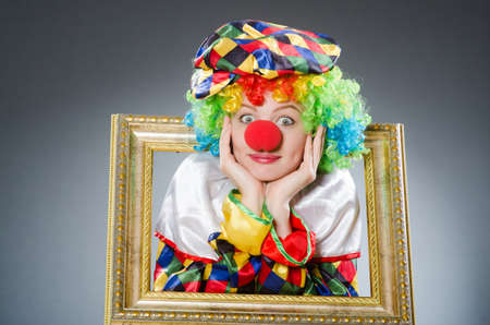 Clown with picture frame in funny conceptの写真素材