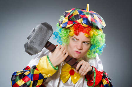 Clown with hammer in funny conceptの写真素材