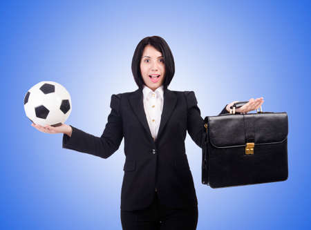 Businesswoman with ball on whiteの写真素材