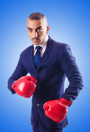Handsome businessman with boxing glovesの写真素材
