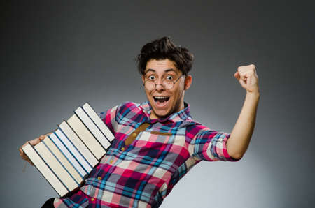 Funny student with many booksの写真素材