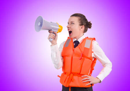 Young woman with vest and loudspeaker on whiteの写真素材