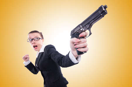 Woman with gun isolated on whiteの写真素材