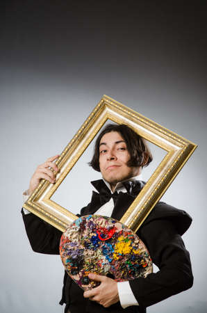 Funny artist in dark studioの写真素材