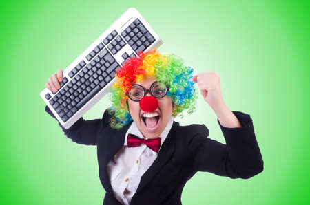 Funny clown with keyboard on whiteの写真素材