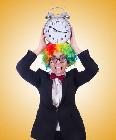 Funny clown with clock on whiteの写真素材