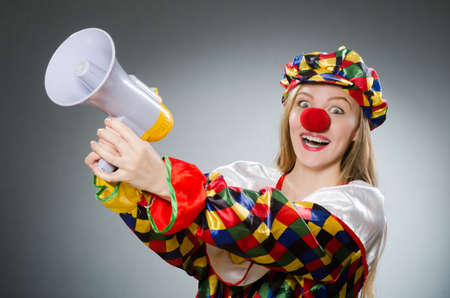 Clown with loudspeaker isolated on whiteの写真素材
