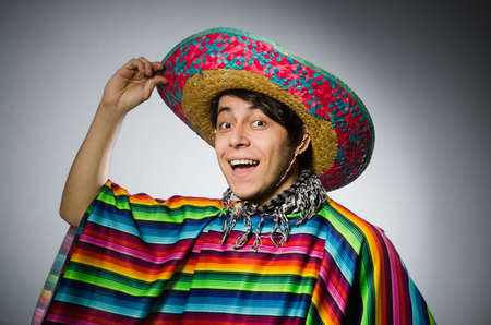 Man in vivid mexican poncho against grayの写真素材