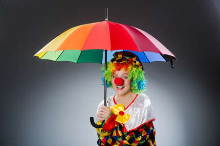 Clown with umbrella in funny conceptの写真素材