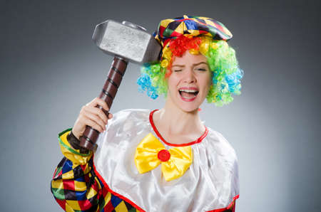 Clown with hammer in funny conceptの写真素材