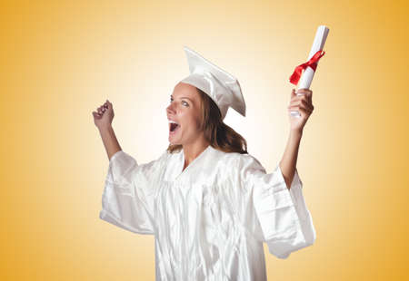 Young student with diploma on whiteの写真素材