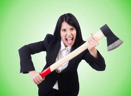 Angry businesswoman with axe on whiteの写真素材