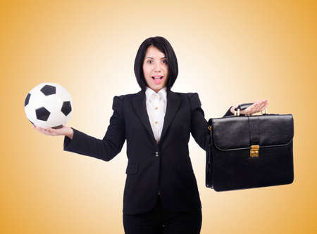 Businesswoman with ball on whiteの写真素材