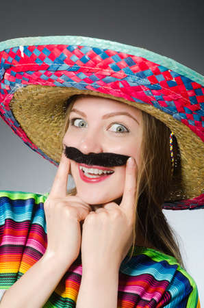 Girl in mexican vivid poncho against grayの写真素材