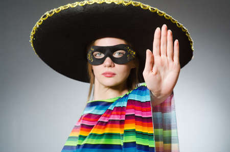Girl in mexican vivid poncho against grayの写真素材