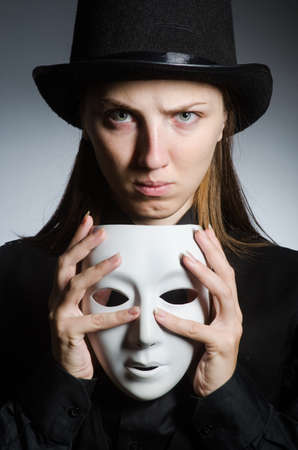 Woman with mask in funny conceptの写真素材