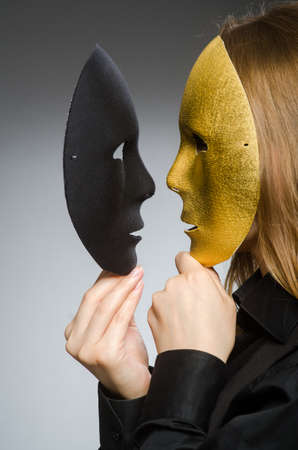 Woman with mask in funny conceptの写真素材