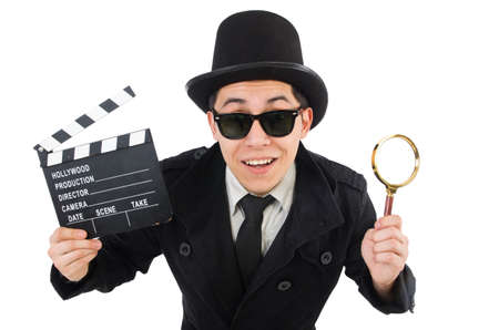 Young detective with clapboard and loupe isolated on whiteの写真素材