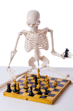 Skeleton playing chess game on whiteの写真素材