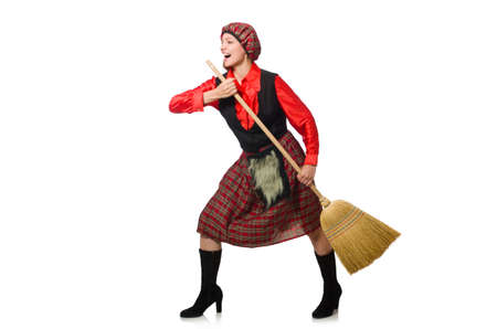 Funny woman in scottish clothing with broomの写真素材