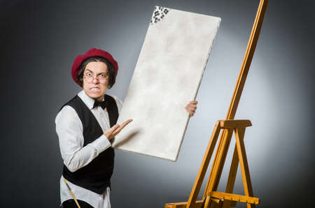 Funny artist in dark studioの写真素材