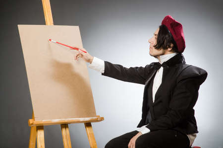 Funny artist in dark studioの写真素材