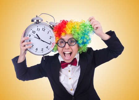 Funny clown with clock on whiteの写真素材