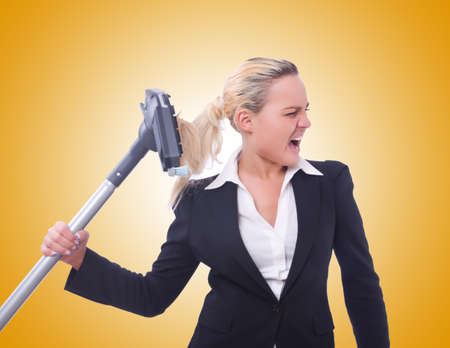 Businesswoman with vacuum cleaner on whiteの写真素材