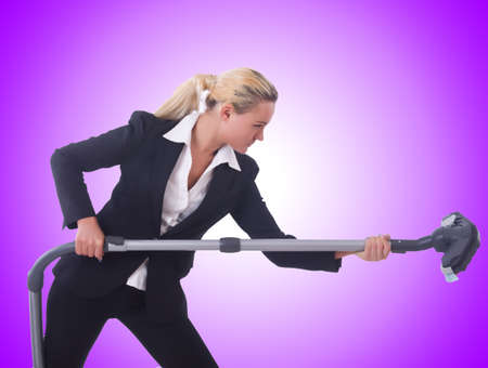 Businesswoman with vacuum cleaner on whiteの写真素材