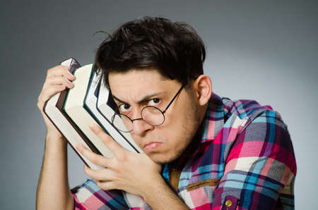 Funny student with many booksの写真素材