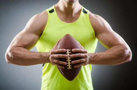 Muscular man with american footballの写真素材