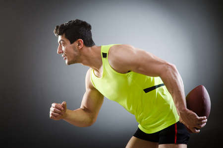 Muscular man with american footballの写真素材