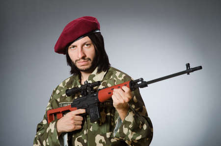 Soldier with handgun against grayの写真素材