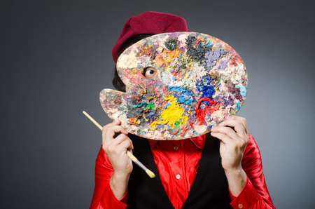 Funny artist in dark studioの写真素材