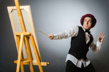 Funny artist in dark studioの写真素材