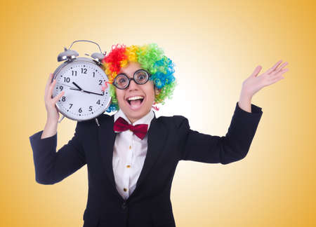 Funny clown with clock on whiteの写真素材